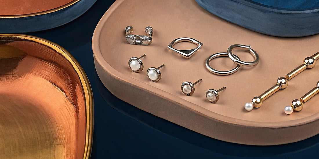 A variety of nose rings in gold and silver, including studs and hoops.