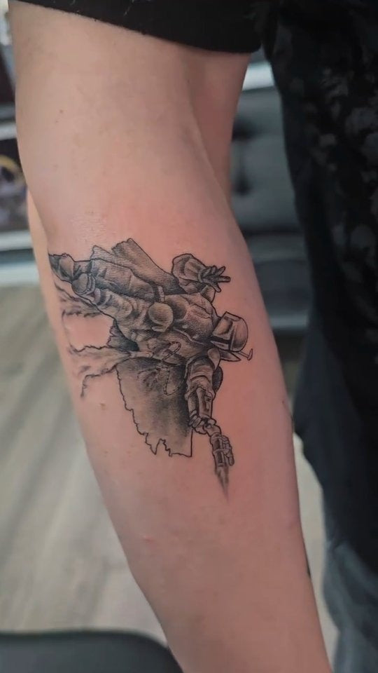 Tattoo by Angel at Z-Edge Gulf Gate: black and grey armored figure on the forearm