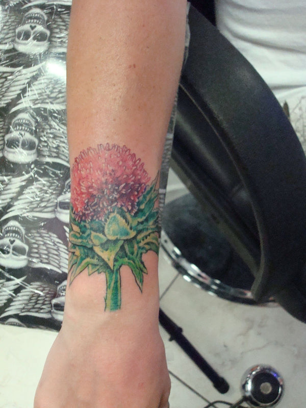 Color protea flower on a wrist