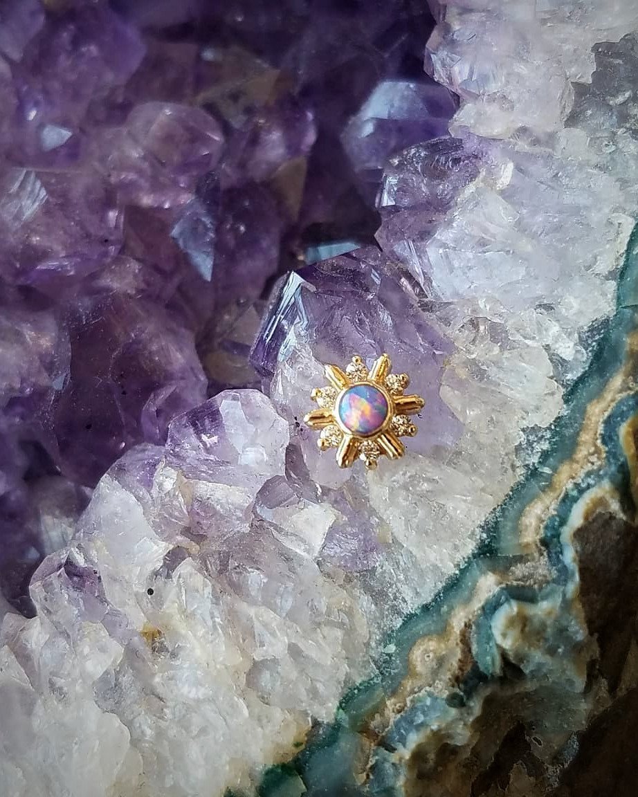 Gold and opal body jewelry at Z-Edge